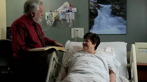 Chaplain speaking with patient Stockbeeldmateriaal 12508120