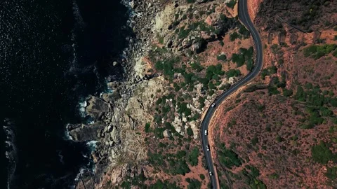 Chapman's Peak Drive along vegetated cliffside, full aerial Stock Footage 340558063