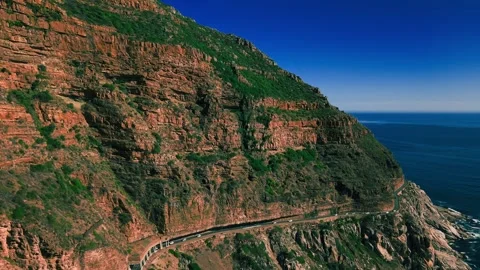 Chapman's Peak Drive cliff road under clear blue sky Stock Footage 340553677