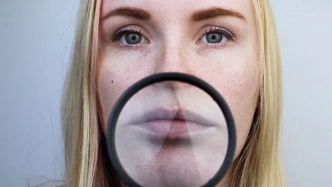 Chapped and dry lips under a magnifying glass. Woman at the doctor’s appointment Stock Footage 121722244