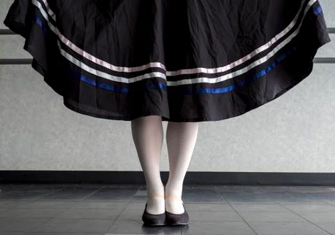Character ballet parallel position with traditional skirt with ribbons held Stock Photos