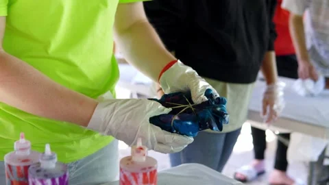 The character examines his painted Tshirt. Staining T -shirts with your own Stock Footage 201891742