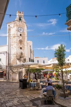 Characteristic square and tower clock with gazebo bar and people tourists in  Stock Photos