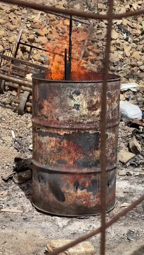 Charcoal barrel fire burning Stock Footage 165533175