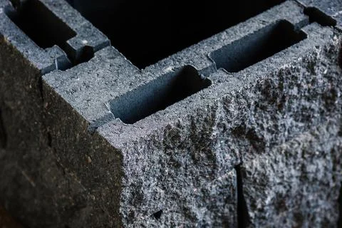 Charcoal black concrete paver with a rectangular hole, creates a sleek and Stock Photos