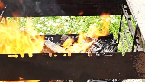 Charcoal burning in the grill getting ready for the summer barbecue, 4K  Stock-Footage 74604034