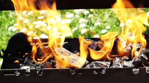 Charcoal burning in the grill getting ready for the summer barbecue, slo Stock-Footage 75505396