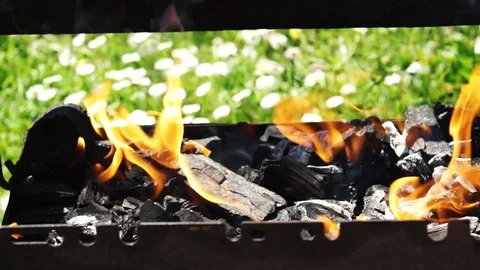 Charcoal burning in the grill getting ready for the summer barbecue, slo Stock Footage 76452482