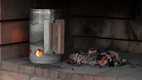 Charcoal Chimney Starter with fire making more embers inside the barbecue Video stock 201262295