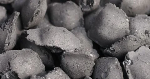 Charcoal compressed from crumbs is obtained under pressure and used to light a Stock Footage 321378166