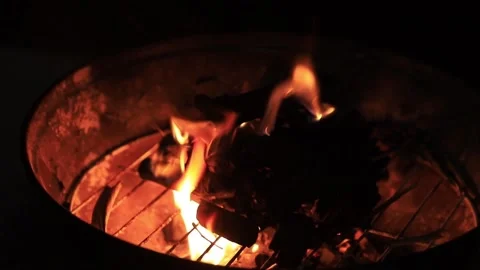 Charcoal fire and flames in a bar-b-cue grill at night Stock Footage 134426229