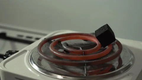 Charcoal for hookahs, spread on a hot electric stove Video stock 255291048
