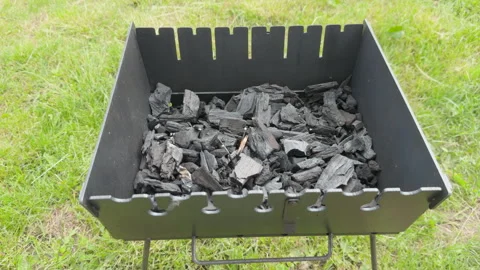 Charcoal igniting and burning in barbecue grill Stock Footage 338408387