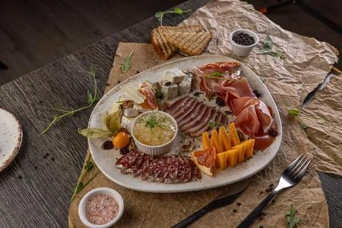 Charcuterie board featuring assorted cheeses Stock Photos