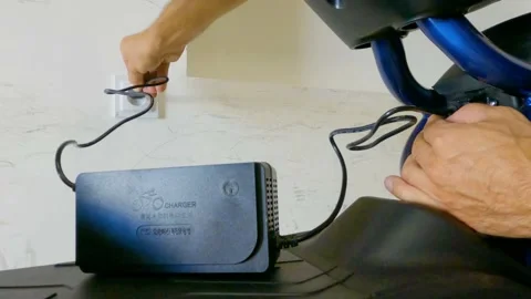Charge the battery electric bike. Socket connection 스톡 동영상 201177137