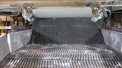 The charge materials are scattered on the sintering machine. Sinter production. Stock Footage 139687789