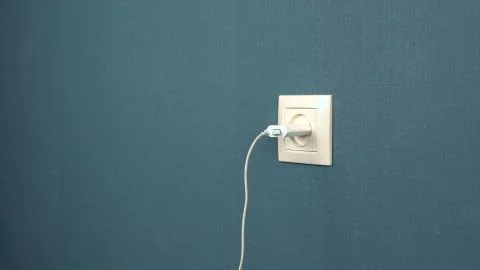 Charger mobile device is inserted into the socket Stock Photos
