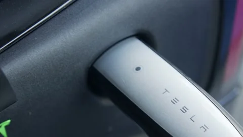 Charger plugged into Tesla Model 3 Stock Footage 154755422