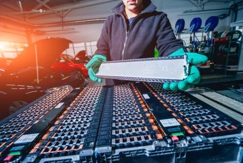 Charging the batteries of the elecric motor. Disassembling the battery Stock Photos