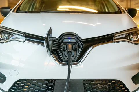 Charging Cable Plugged Into Front Port of White Car Stock Photos