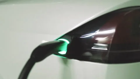 Charging cable is plugged into socket. Electric vehicle charging port plugging 스톡 동영상 194510688