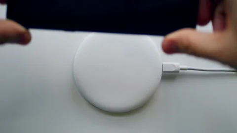 Charging of a cellphone from a wireless device. Wireless charging concept. Video stock 107230496