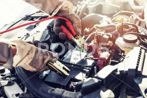Charging dead car battery with jumper cables Stock Photos