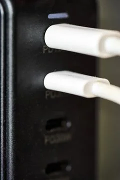 Charging device with two plugged cables Stock Photos