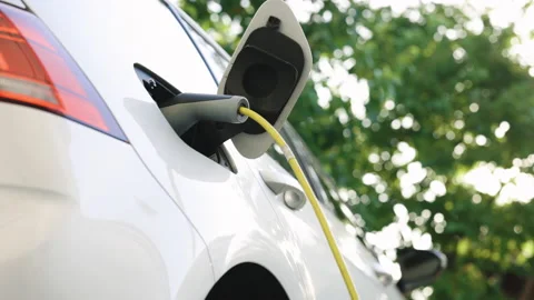 Charging electric car. Environmentally friendly electric car being charged. Car Stock Footage 200832147