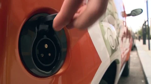 Charging electric car. Plugging in and unplugging from charging station Stock Footage 78358287