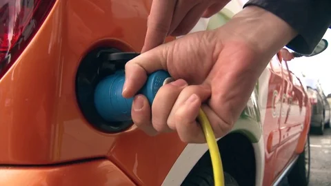 Charging electric car. Plugging in and unplugging from charging station Stock Footage 78358464