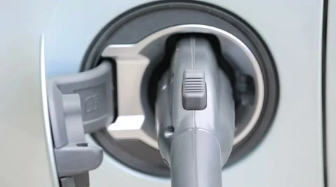 Charging electric car in residential garage. Stock Footage