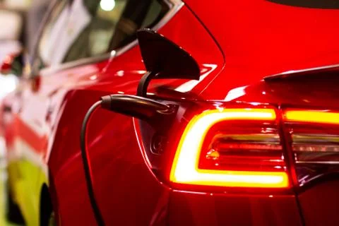 Charging an electric Tesla model S with the power cable supply plugged in, Pr Stock Photos