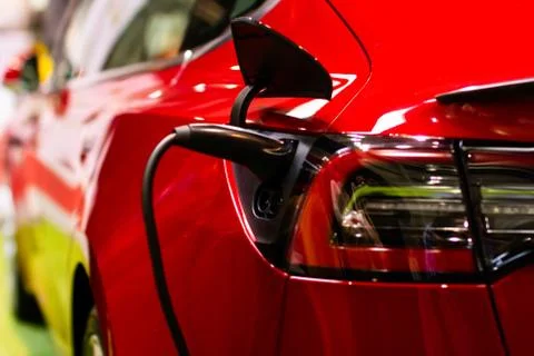 Charging an electric Tesla model S with the power cable supply plugged in, Pr Stock Photos