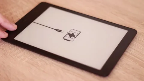 Charging Electronic tablet  on table 動画素材 166210090