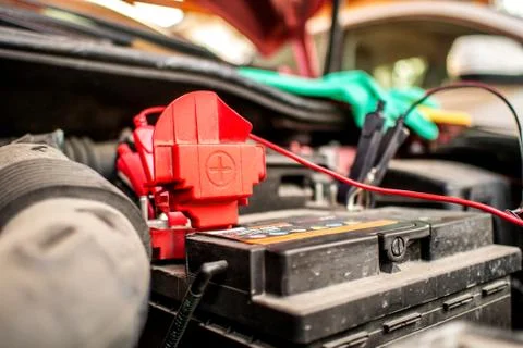 Charging an empty car accumulator with battery charger Stock Photos