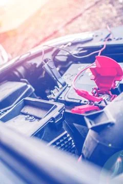 Charging an empty car accumulator with battery charger Stock Photos
