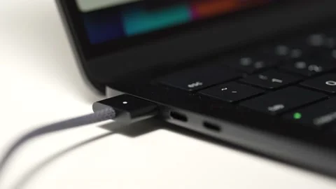 Charging a Laptop Computer With a Magnetic Power Cable Stock Footage 223262466