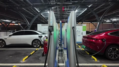 Charging at at modern high-speed EV station at nigh Video stock 330884182