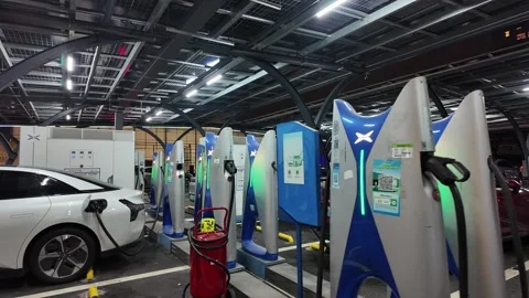 Charging at a modern high-speed EV station at night Video stock 330884223