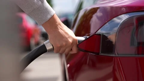 Charging a Modern red Car Stock Footage 249919892