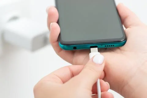 Charging modern smartphone via usb type-c cable Stock Photos