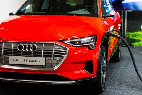 Charging an plug-in hybrid Audi e-tron 55 quattro with the power cable supply Stock Photos