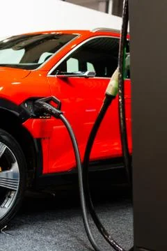 Charging an plug-in hybrid Audi e-tron 55 quattro with the power cable supply Stock Photos