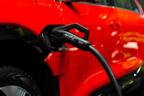 Charging an plug-in hybrid Audi e-tron 55 quattro with the power cable supply Stock Photos