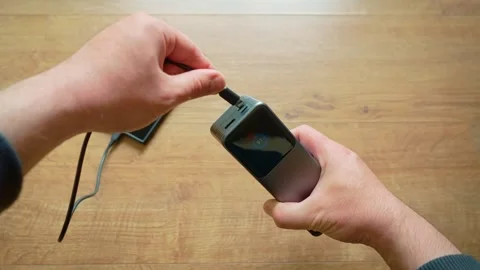 Charging smartphone from power bank using USB cable close up portable external Stock Footage 334847556