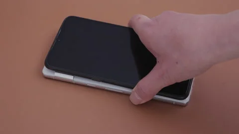 Charging a smartphone using the battery share function of Google Pixel 7 Pro Stock Footage 219440827