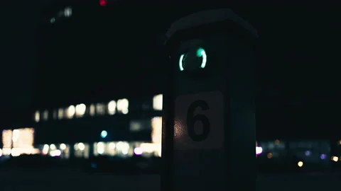 Charging station for electric EV vehicles in the snow with bokeh lights in Stock Footage 225773958