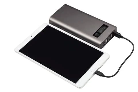 Charging tablet. Stock Photos