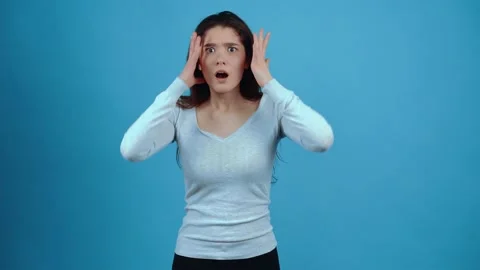 The charismatic, amazed face points with her index finger at her then raises her Stock Footage 154316061